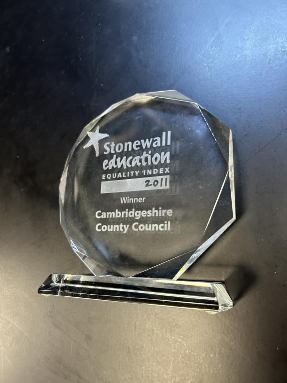 Image shows a round glass trophy with the words "Stonewall education awards 2011- Cambridgeshire County Council" on